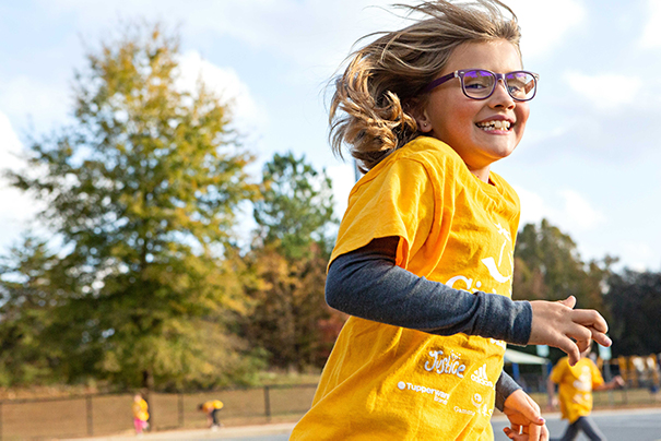 Girls on the Run participant smiling while running